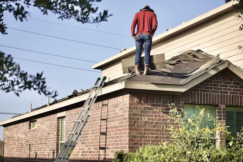 Professional roofer working on a residential roof in Redan